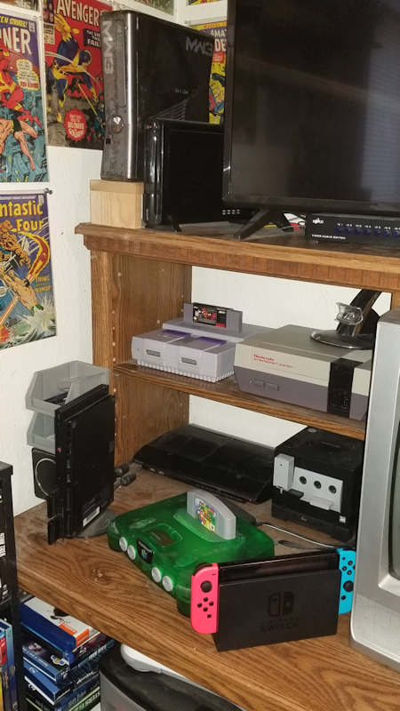 Assorted and Random Retro Video Game Consoles on Entertainment Center